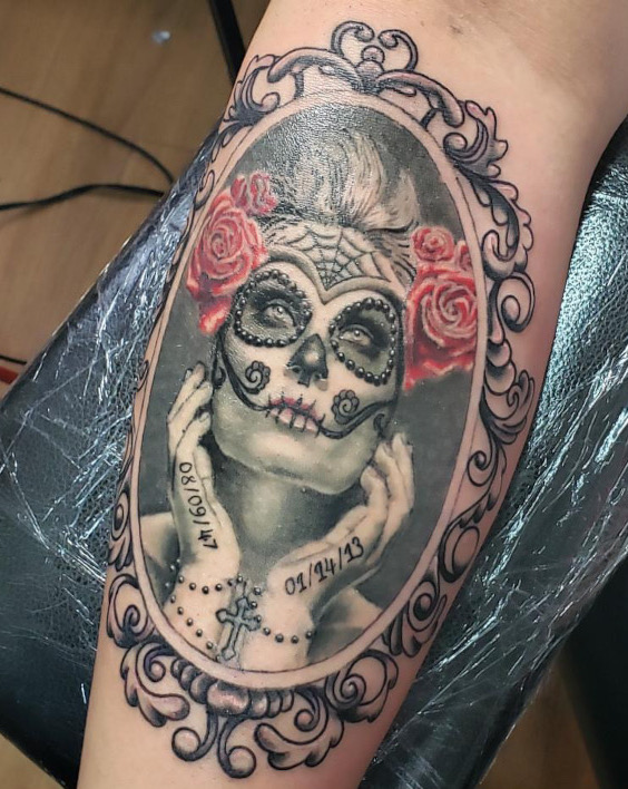 Black and grey realistic portrait tattoo with day of the dead makeup and red roses by Britney Farmer of Sacred Mandala Studio.